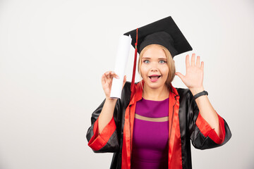 Happy student in gown received diploma on white background