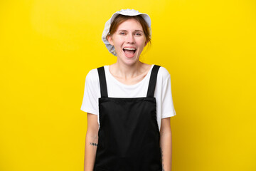Young English fisherwoman isolated on yellow background with surprise facial expression