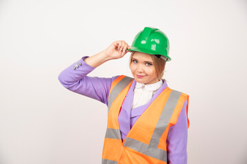 Young woman builder in helmet on white background