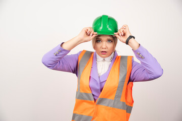 Woman builder in helmet on white background