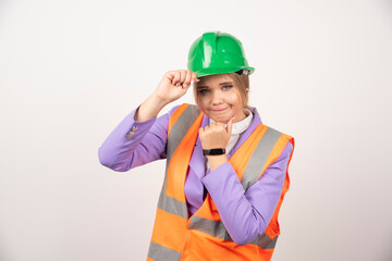 Woman builder in helmet on white background