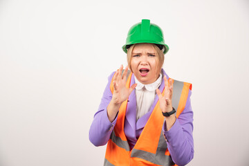 Female builder in helmet on white background