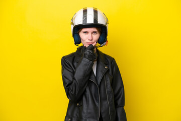 Young English woman with a motorcycle helmet isolated on yellow background thinking