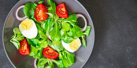 salad egg, vegetables, tomato, onion, leaves lettuce green mix petals fresh healthy meal food snack diet on the table copy space food background rustic top view keto or paleo diet