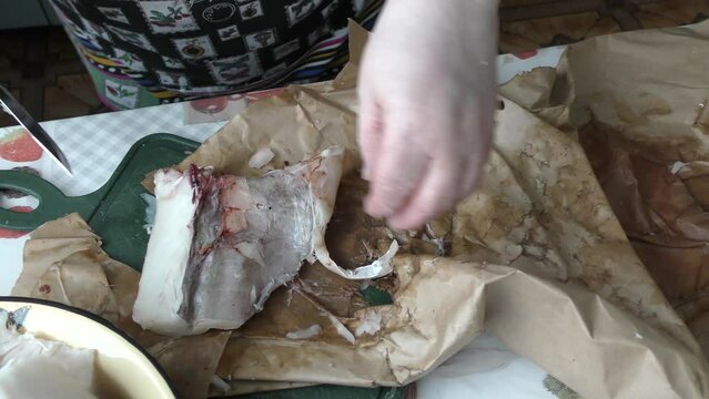 the cook cuts into pieces sea fish cod