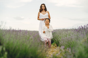 Fototapeta na wymiar Little girl with her mother in a lavender field