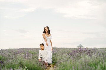 Little girl with her mother in a lavender field