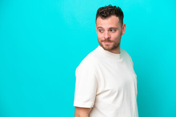 Young Brazilian man isolated on blue background . Portrait