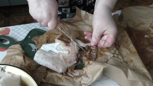 the cook cuts into pieces sea fish cod