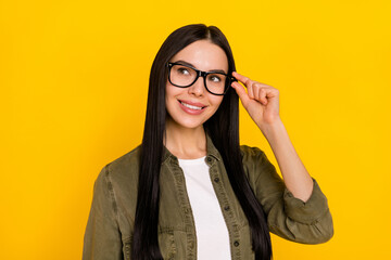 Photo of sweet millennial lady look promo wear spectacles khaki outfit isolated on yellow color...