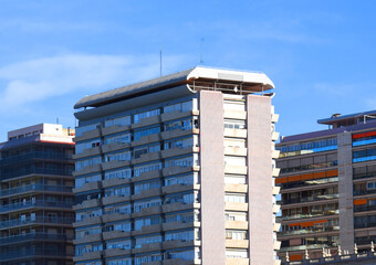 Fototapeta premium Facade building in Spain. Residential building with balconies. Colorful buildings and hotel apartments. Facade of residential building in Spain. House with window and balcony. Buildings architecture..