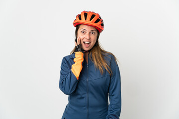 Middle age cyclist woman isolated on white background with surprise and shocked facial expression