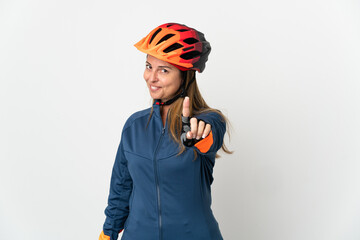 Middle age cyclist woman isolated on white background showing and lifting a finger