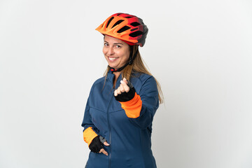 Middle age cyclist woman isolated on white background making money gesture
