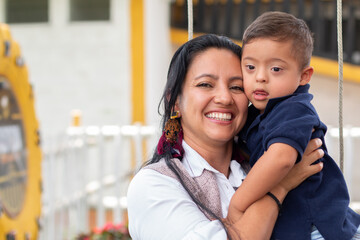 Portrait of a child with Dawn syndrome and his mother. Concept of inclusivity and diversity.