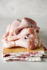 Raw Chicken Legs on Wooden Tray Napkin Vertical