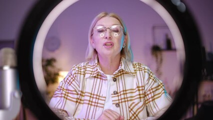 Senior woman recording video for her blog, modern technology, influencer