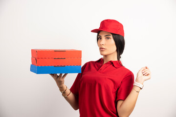 Delivery woman with pizza posing on white background