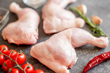 raw chicken legs on stone background