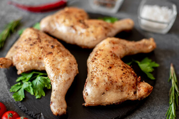 Grilled chicken legs on stone background