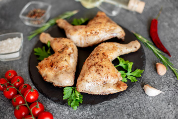 Grilled chicken legs on stone background