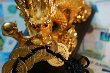 A dragon with Chinese coins in his teeth. Religious and spiritual symbol.