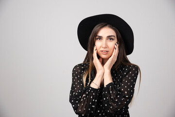 Stylish woman with black hat looking at camera