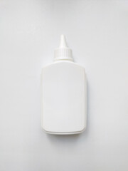 White plastic glue bottle isolated on white background. 