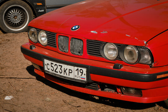 Leningrad Region, Russia - June 2022. Old stylish red retro BMW car bumper close-up. Front view. Car exhibition, festival outside.