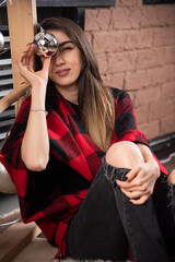 Young woman model posing with checkered plaid near Christmas balls