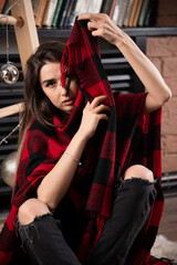 Young woman model posing with checkered plaid near Christmas balls