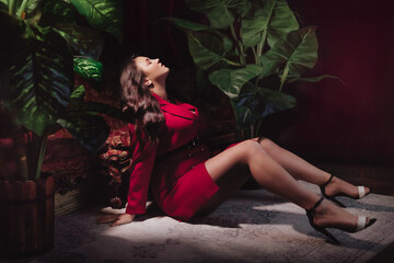 Obraz na płótnie Canvas Happy plus size woman with love tourself concept. Portrait of beautiful young woman in red clothes on the background of tropical plants. Overweight concept.