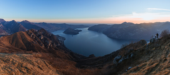 Obraz premium View of Lake Iseo at sunset, with the alps framing it, near the town of Zone, Italy - February 2022.