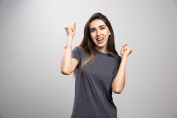 Happy young woman looking at camera with joyful and charming smile