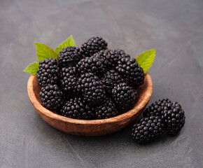 Sweet blackberry in wooden plate