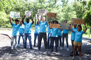 Group of volunteer protest against earth pollution and global warming, people hold protest signs and raise them up to motivate people to do charity work and save planet, aware of natural environment.