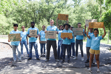 Group of volunteer protest against earth pollution and global warming, people hold protest signs and raise them up to motivate people to do charity work and save planet, aware of natural environment.