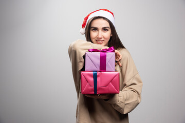 Young woman showing two Christmas presents