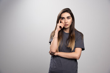 Studio portrait of young woman thinking and looking away