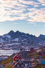 Night time in the northern hemisphere concept - Picturesque village on coast of Greenland - Colorful houses in Tasiilaq, East Greenland © muratart