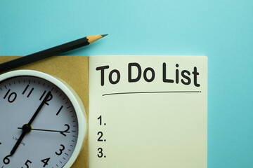 To Do List,Memo,notepad,planning concept.,Notebook with To Do List word and white alarm clock on light blue background with copyspace.
