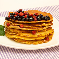 pancakes, pancakes with berries on a colored background