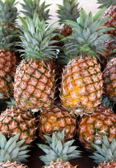 A stack of pineapples for sale at a market