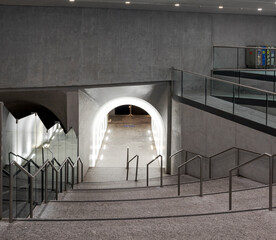 Underground walkway with a tunnel and stairs in Swiss railway station. Scene illuminated by spotlights and led light