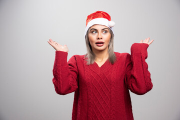 Beautiful woman in red sweater getting shocked