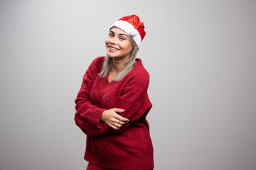 Beautiful woman in red sweater smiling widely