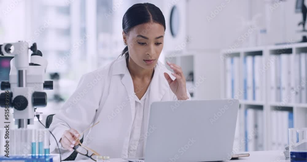Poster A chemist having pain from a headache or migraine due to workload and a deadline in a laboratory. Stressed scientist using a laptop in a laboratory while suffering from stress and burnout.
