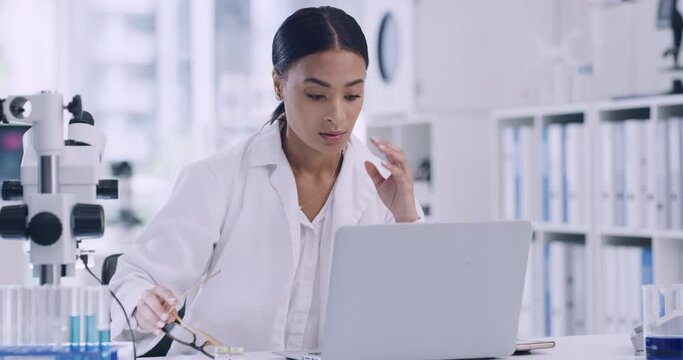 A chemist having pain from a headache or migraine due to workload and a deadline in a laboratory. Stressed scientist using a laptop in a laboratory while suffering from stress and burnout.