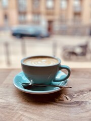 cup of cappuccino, morning coffee in a cafe, a view of the city from the cafe window