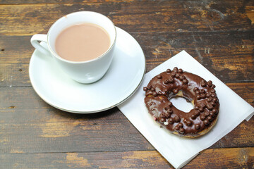chocolate donut and a cup of chocolate milk
